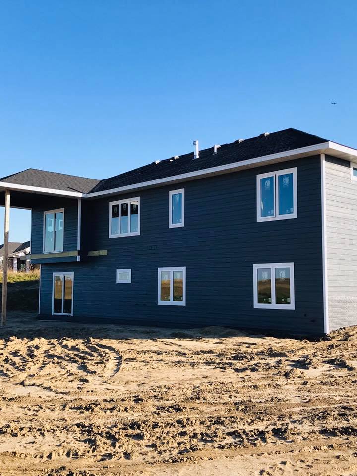 Navy blue exterior siding repaint on a new construction split-level, RPS Painting, Sioux Falls SD.